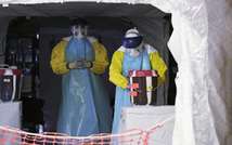 Medical workers wash their hands in an Ebola treatment centre in Monrovia on December 20, 2014 (Evan Schneider (UN/AFP))