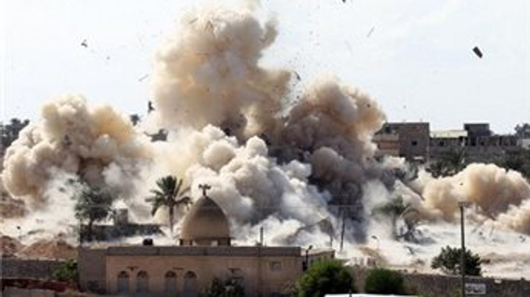 Smoke rises after a house is blown up during an operation by Egyptian security forces in Rafah near the border with southern Gaza on October 29, 2014