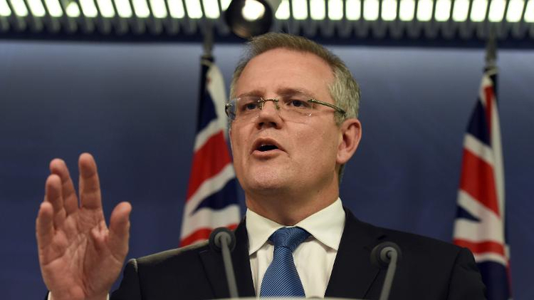 Australian Immigration Minister Scott Morrison announces in Sydney on July 25, 2014, that a group of 157 asylum-seekers in custody on the high seas for weeks will be taken to Australia and held until consular officials confirm their nationalities