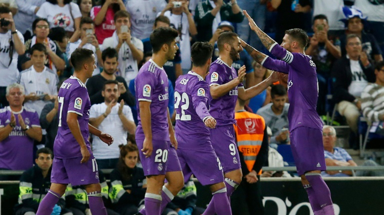 Real Madrid's French forward Karim Benzema celebrates with teammates after scoring during the Spanish league football match RCD Espanyol vs Real Madrid CF at the Cornella-El Prat stadium on September 18, 2016