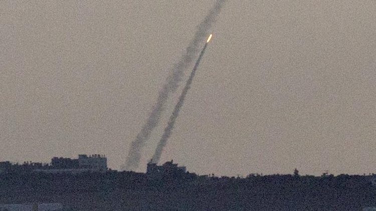 A picture taken from the southern Israeli city of Sderot shows rockets being launched from the Gaza Strip into Israel, on July 15, 2014