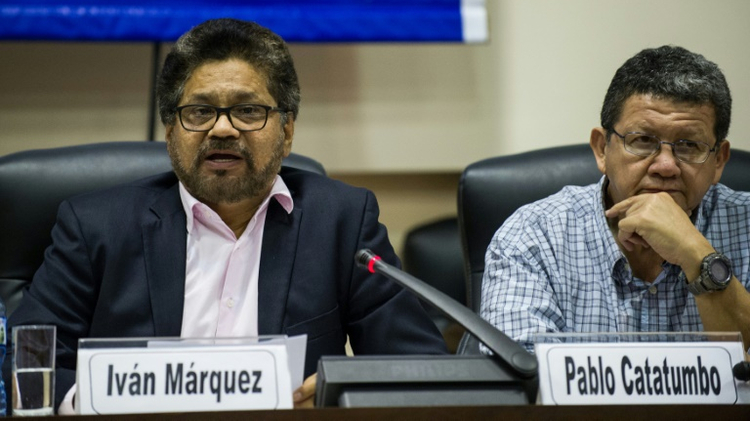 The head of the FARC delegation to peace talks, Ivan Marquez (L), speaks during a press conference at the Convention Palace in Havana on January 19, 2016
