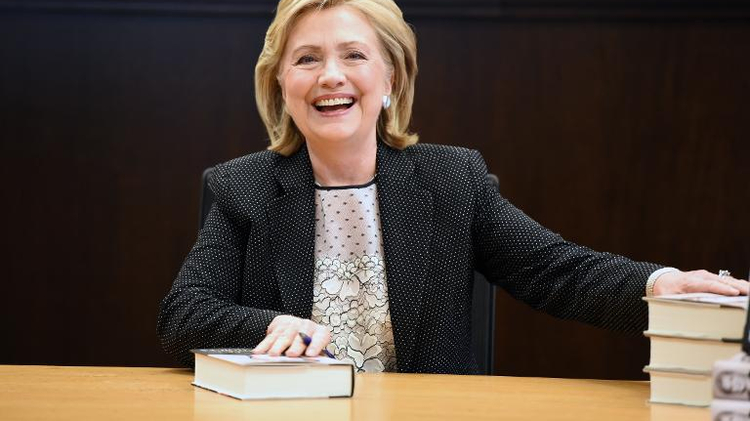 Former US secretary of state Hillary Clinton poses with her book "Hard Choices" at a book signing event in Los Angeles, California June 19, 2014
