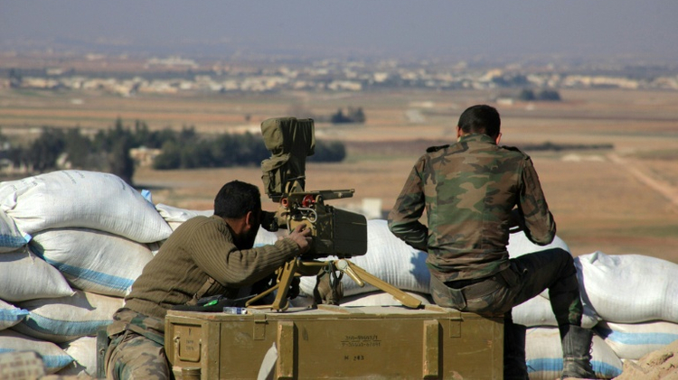 Syrian pro-government fighters guard a post in the Tal Sharba area on the outskirts of the northern Syrian city of Aleppo on December 27, 2015 after they seized the area from Islamic State (IS) group jihadists