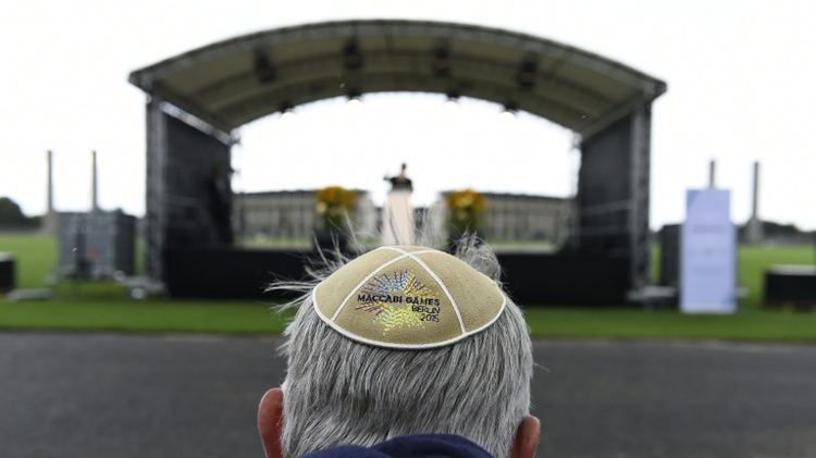A man wears a Kippa at the so-called "Maifeld" near the Olympic Stadium of Berlin, during a Memorial ceremony for the victims of the Holocaust before the official opening ceremony of the 14th European Maccabi Games in Berlin, on July 28, 2015