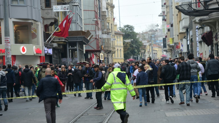 Turkish police push people away after an explosion on the pedestrian Istiklal avenue in Istanbul on March 19, 2016