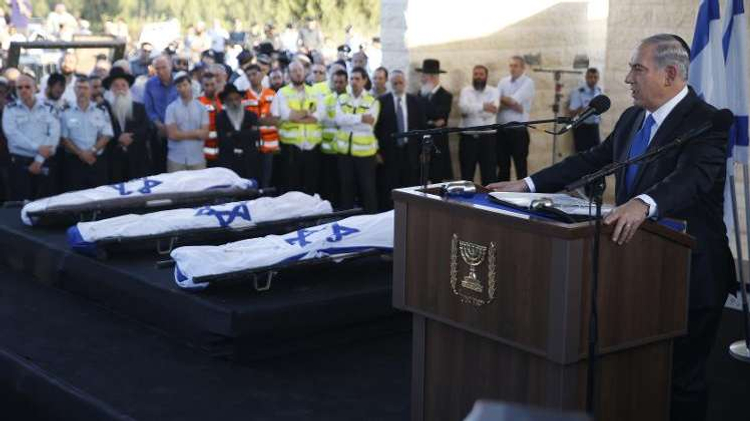 Israeli Prime Minister Benjamin Netanyahu delivers a speech on July 1, 2014 in the cemetery of Modiin during the funeral of Gilad Shaer and Naftali Frenkel, both 16, and 19-year-old Eyal Ifrach