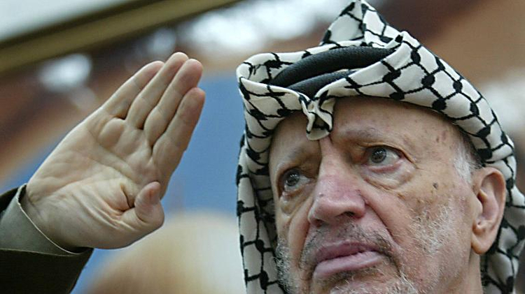 Palestinian leader Yasser Arafat waves in the West Bank City of Ramallah, on July 10, 2003