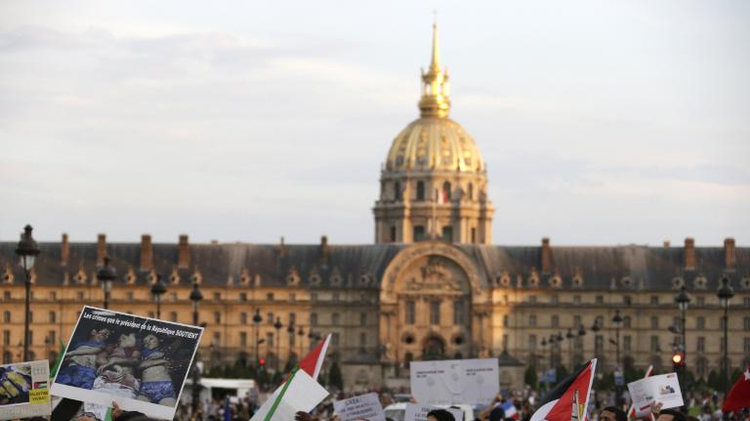 People gather in front of the Invalides during a demonstration to denounce Israel's military campaign in Gaza on July 23, 2014 in Paris