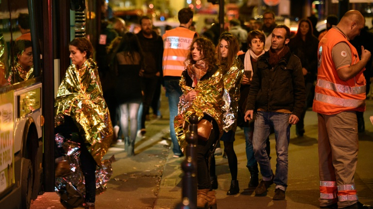 People are evacuated by bus, near the Bataclan concert hall in central Paris, on November 14, 2015