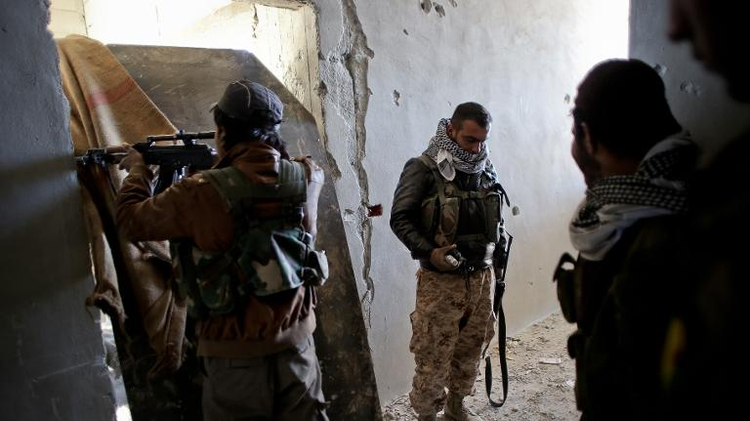 Fighters of the Syrian Kurdish People's Protection Units (YPG) hold a position during fighting against Islamic State (IS) group, in the Syrian besieged border town of Ain al-Arab (known as Kobane by the Kurds), on November 7, 2014