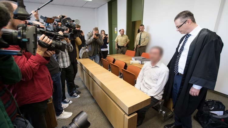 Vucelic V., accused of helping to prepare a terror attack after police found Kalashnikovs and explosives hidden in his car while he was driving to Paris last November, arrives at the courtroom of the Munich District Court on September 23, 2016