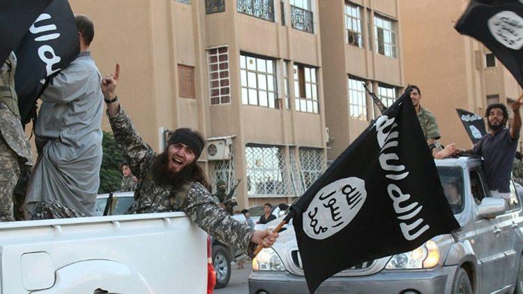 The black flag is waved by the Islamic State group in the northern rebel-held Syrian city of Raqa, in this image provided Jihadist media outlet Welayat Raqa