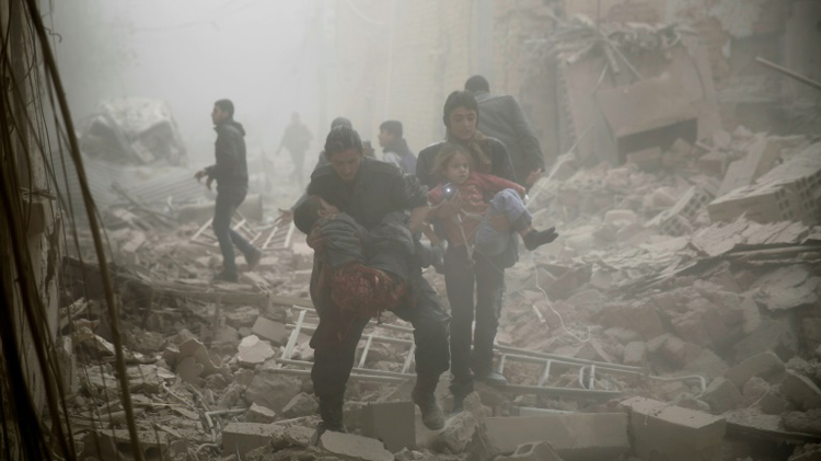 People evacuate victims following air strikes on Douma in the eastern Ghouta region on December 13, 2015