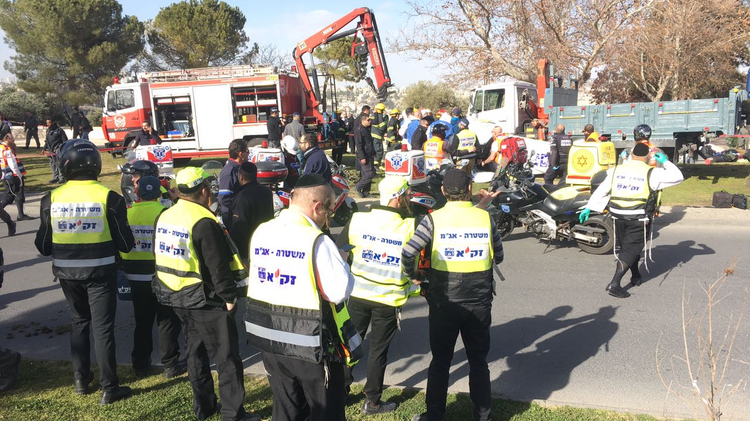 Emergency responders on the scene of a suspected truck ramming attack on January 8, 2016 in Jerusalem