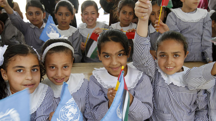 Palestinian school children attend the opening of a UN Relief and Works Agency (UNRWA) school in northern Gaza Strip