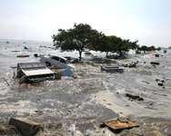 Cars and parts of buildings churn in the surf on Marina beach in Madras, India, on December 26, 2004, as tidal waves hit the coast ( AFP/File )