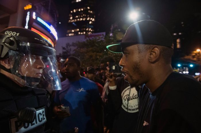 Several hundred people taunted riot police in Charlotte, North Carolina during a second night of unrest ignited by the fatal police shooting of a black man Nicholas Kamm (AFP)