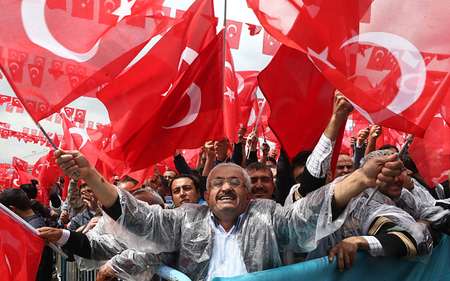 Supporters cheer Turkey's President Recep Tayyip Erdogan as he addresses an election rally in Golbasi - AFP AFP