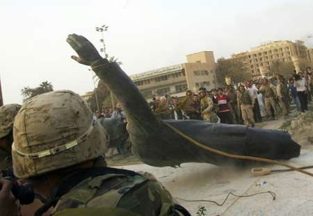 A statue of Saddam Hussein is pulled down by a US armoured vehicle in Baghdad on April 9, 2003 ( RAMZI HAIDAR (AFP/File) )
