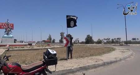 Image grab from video uploaded on May 18, 2015 by Aamaq News Agency, allegedly shows an IS fighter holding the group's flag in a street of Ramadi, the Iraqi capital of Anbar province, a day after the city was captured by IS - AAMAQ NEWS VIA YOUTUBE/AFP AAMAQ NEWS VIA YOUTUBE/AFP