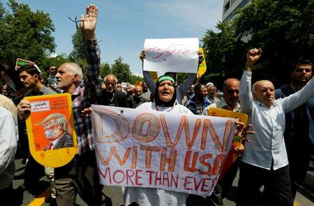 Iranians hold placards bearing anti-US slogans during a demonstration after Friday prayers in the capital Tehran