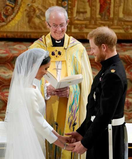 The bride and groom held hands and giggled at the altar ( Owen Humphreys (POOL/AFP) )