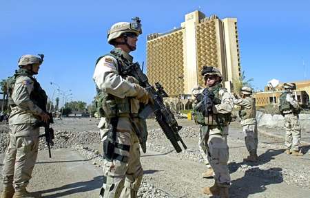 US soldiers secure the area in front of the Palestine Hotel in Baghdad on October 25, 2005 a day after a triple suicide car bombing hit the compound ( Ahmad al-Rubaye (AFP/File) )