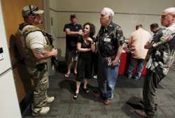 A police officer prevents attendees from leaving the Muhammad Art Exhibit and Contest after it was reported that shots were fired outside the venue and a man is down in Garland, Texas May 3, 2015. - Reuters Reuters