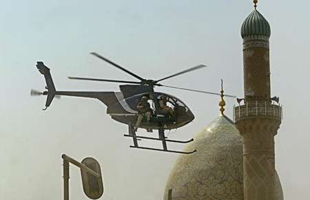 A helicopter from the US private security firm Blackwater flies over central Baghdad, Iraq in 2005 - Yuri Cortez (AFP/File) Yuri Cortez (AFP/File)