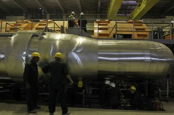 Workers work in a part of the electricity generating plant of the Bushehr nuclear power plant, just outside the southern city of Bushehr, Iran, Tuesday, Oct. 26, 2010.