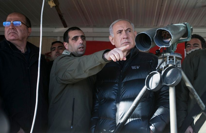 FILE: Israel's Prime Minister Benjamin Netanyahu, center, and former Defense Minister Moshe Yaalon, left, stand next to Israeli soldiers at a military outpost during a visit at Mount Hermon in the Israeli-controlled Golan Heights overlooking the Israel-Sy