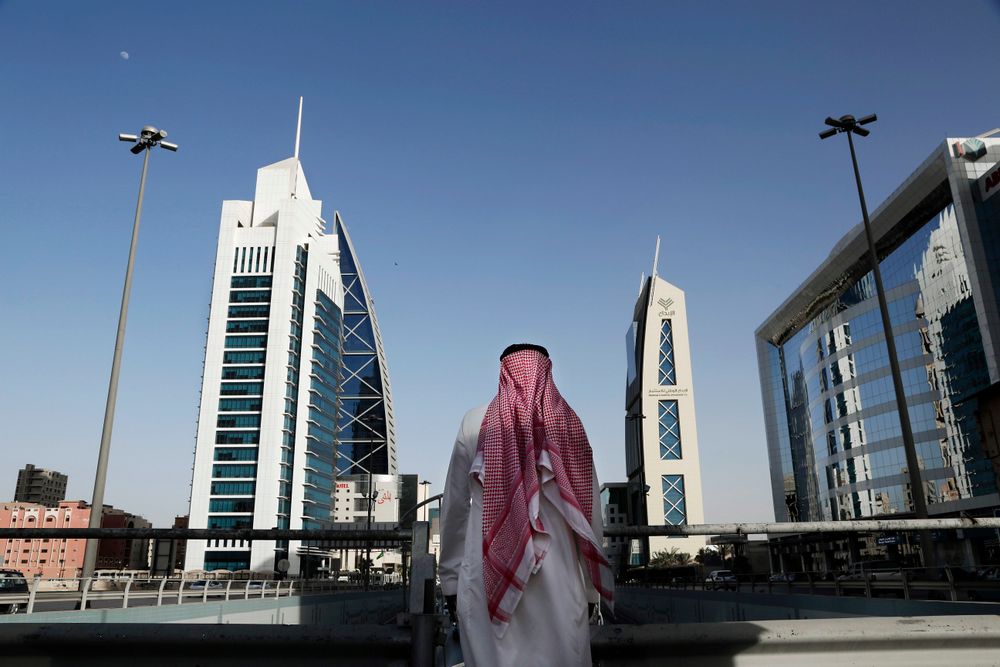 A Saudi man looks at buildings on a bridge in Riyadh, Saudi Arabia, on June 23, 2018