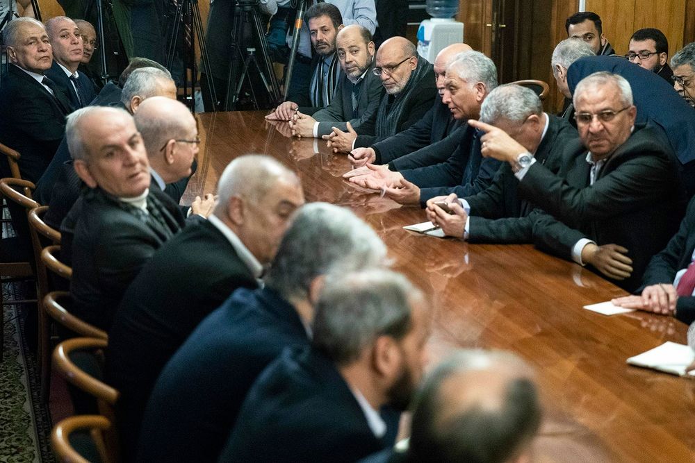 Fatah and Hamas officials wait for a meeting with Russian Foreign Minister Sergei Lavrov and representatives of Palestinian groups and movements in Moscow, Russia, Tuesday, Feb. 12, 2019.