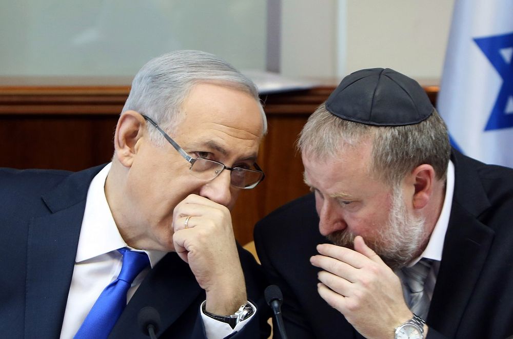 FILE - Israel's Prime Minister Benjamin Netanyahu, left, speaks with Cabinet Secretary Avichai Mandelblit during the weekly cabinet meeting in Jerusalem, Sunday, Dec. 20, 2015.
