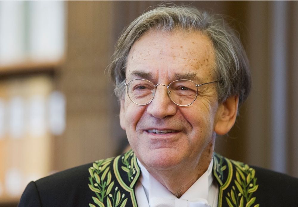 FILE: French Philosopher Alain Finkielkraut, wearing the French Academician's outfit, displays his ceremonial epee in the library of the Institut de France before a ceremony in Paris, Thursday Jan 28, 2016.