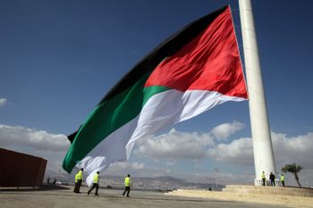 A Jordanian flag is raised during a celebration marking the centennial of the Arab Revolt against the region’s ruling Ottoman Turks, in Jordan’s Red Sea port of Aqaba, Saturday, Jan. 23, 2016.