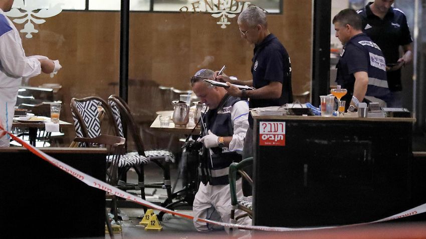 Israeli forensic police inspect a restaurant following a shooting attack at a shopping complex in the Mediterranean coastal city of Tel Aviv on June 8, 2016.