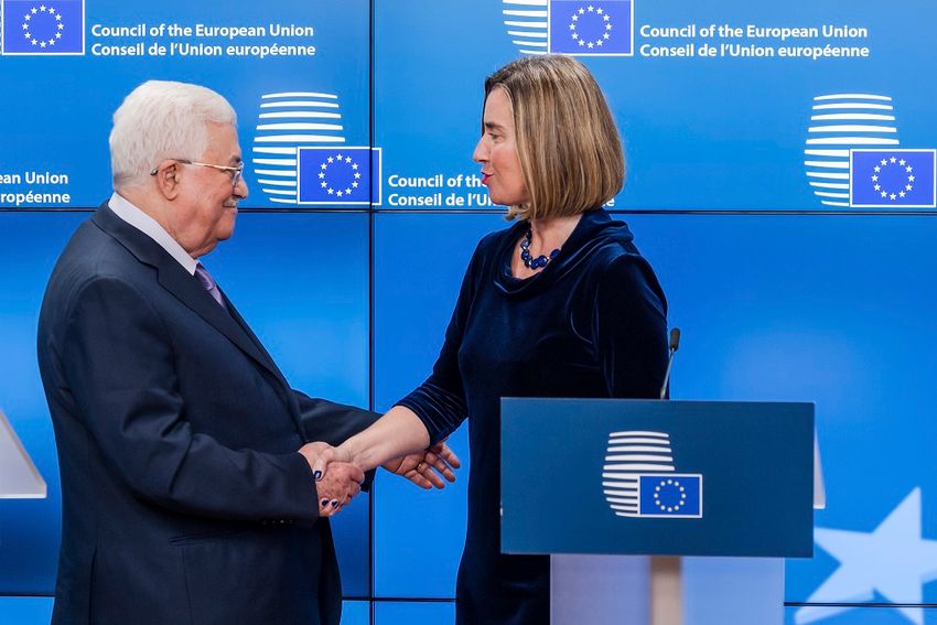 European Union foreign policy chief Federica Mogherini, right, shakes hands with Palestinian President Mahmoud Abbas after they addressed the media at the EU Council in Brussels on Monday, Jan. 22, 2018. French Foreign Minister Jean-Yves Le Drian said Mon
