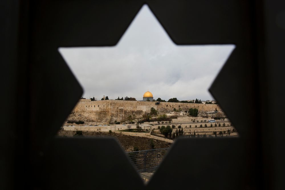 Jerusalem's Old City is seen through a door with the shape of star of David, in Jerusalem, December 6, 2017