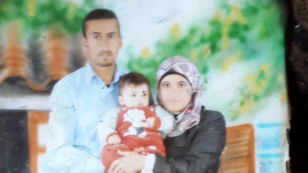 A photo shows the Dawabsheh family holding their toddler who was killed in an arson attack on Thursday July 30, 2015