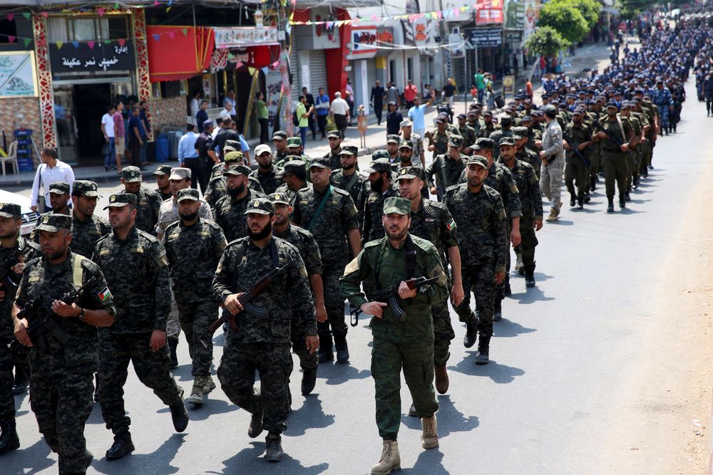 Officers from Hamas national security force hold their rifles while marching during a parade against Israeli arrangements in the contested Jerusalem shrine, in front of the Palestinian Legislative Council in Gaza City, Wednesday, July 26, 2017.