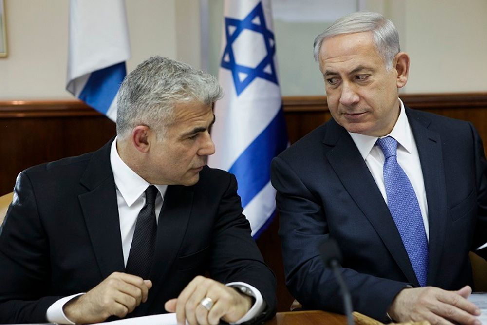 FILE: Israeli Prime Minister Benjamin Netanyahu, right, speaks with former Finance Minister Yair Lapid during a cabinet meeting in Jerusalem Tuesday, Oct. 7, 2014.