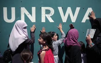 Palestinians demonstrate against a U.N. Relief and Works Agency (UNRWA) funding gap that could keep about 500,000 Palestinian students out of school this fall, outside the UNRWA Gaza Headquarters in Gaza City, Sunday, Aug. 16, 2015. The deputy chief of th