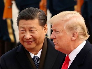 FILE - In this Nov. 9, 2017, file photo, U.S. President Donald Trump and Chinese President Xi Jinping participate in a welcome ceremony at the Great Hall of the People in Beijing, China. This last week, China demanded the United States stop sending ships