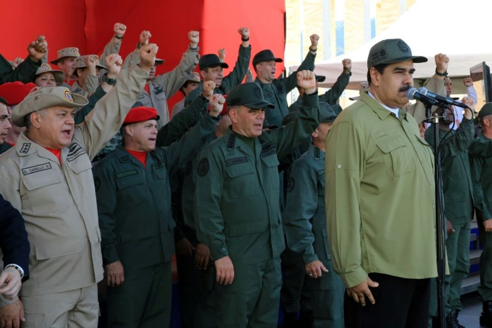 Venezuelan President Nicolas Maduro (R) delivering a speech during a military parade in December 2018: nine senior members of the military were sentenced to jail terms a week later for allegedly trying to topple the Socialist leader in 2014