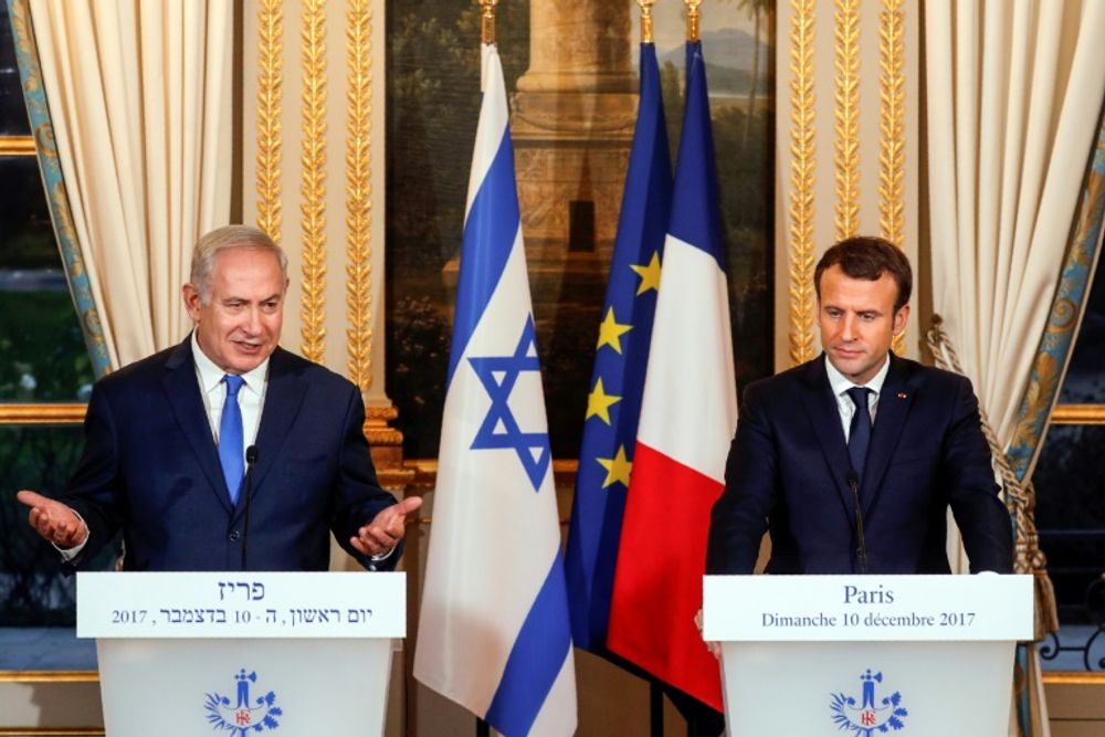 Israeli Prime Minister Benjamin Netanyahu (L) and French President Emmanuel Macron speak at a joint news conference following their meeting at the Elysee Palace in Paris in December 2017