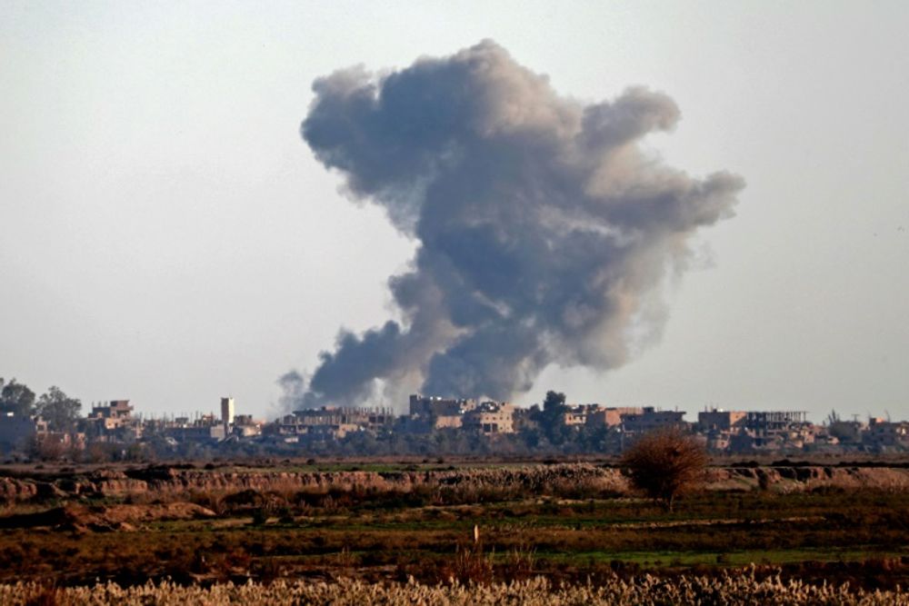 Smoke billows over the outskirts of Hajin in Syria's eastern Deir Ezzor province on December 15, 2018 after US-backed forces expelled the Islamic State group from the village
