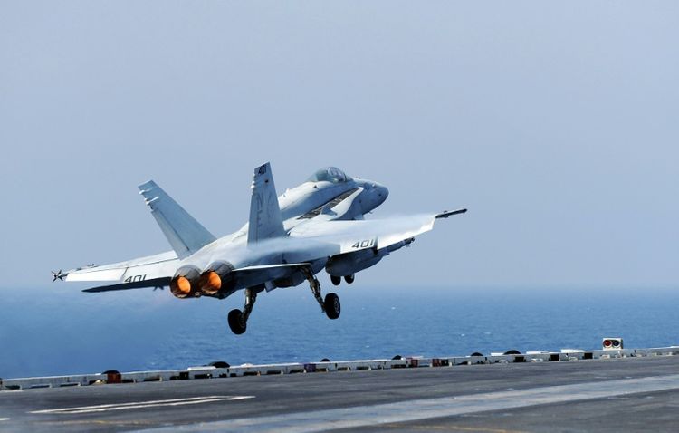 A US Navy handout photo shows an F/A-18C Hornet jet fighter as it launches on October 20, 2010 from the aircraft carrier USS Abraham Lincoln in the Gulf of Oman