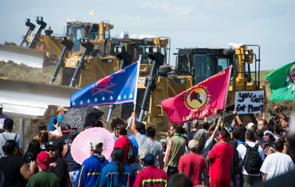 Members of the Standing Rock Sioux Tribe confront bulldozers working on the Dakota Access Pipeline in an effort to make them stop near Cannon Ball, North Dakota on September 03, 2016